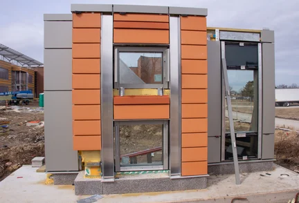 A mockup of a completed exterior wall assembly at a construction site.