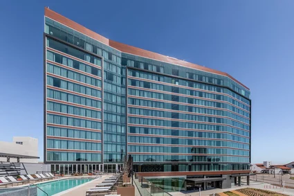 A completed multilevel building featuring prefabricated ribbon windows adorning its exterior.