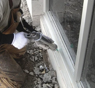 A polyurethane sealant is applied to repair the bead of a failed silicone-based weather barrier.