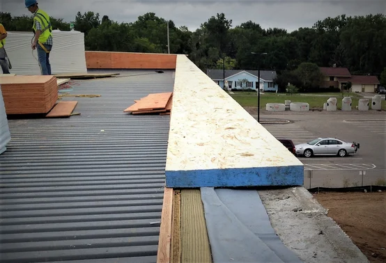 The top of a parapet wall shown under construction.