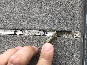 An example of sealant bead between two substrates that has failed due to improper application and/or prolonged weather exposure.