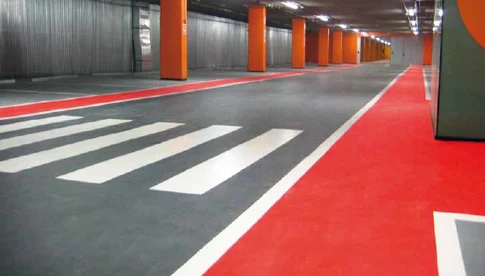 The interior flooring of a concrete parking structure is shown with a  Polyurethane Methacrylate (PUMA) waterproof coating applied to the surface.