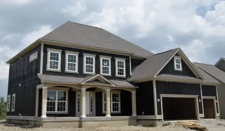 A completed residence featuring above-grade sheathing to enhance weather durability.