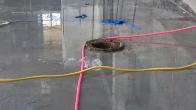 An example of concrete deck flooring poured incorrectly around a drain - flooring must be flush for proper water removal.