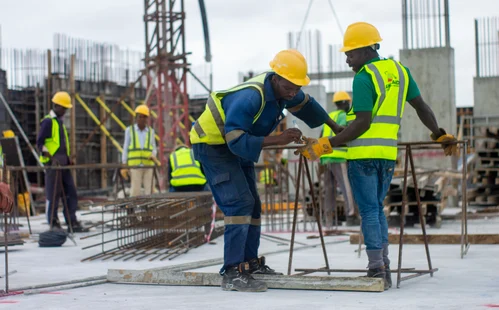 Job site workers checking rebar assemblies to ensure that they adhere to FORTIFIED Silver construction standards.