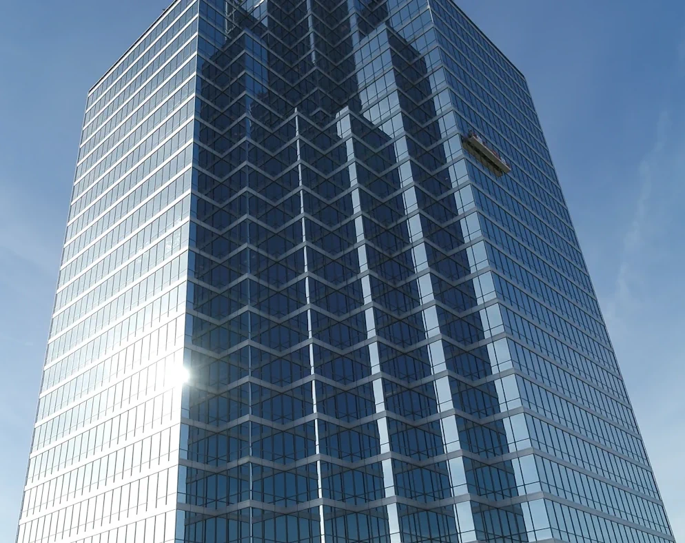 The picture shows a skyscraper with glass paneling and a glass façade.   